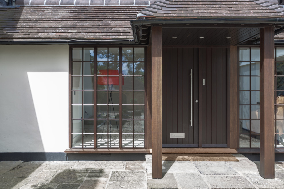 Photo of a medium sized contemporary front door in Hampshire with white walls, a dark wood front door and a single front door.