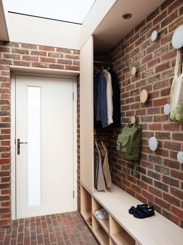 Small contemporary foyer in Hertfordshire with brick flooring, a single front door, a grey front door, a wood ceiling and brick walls.