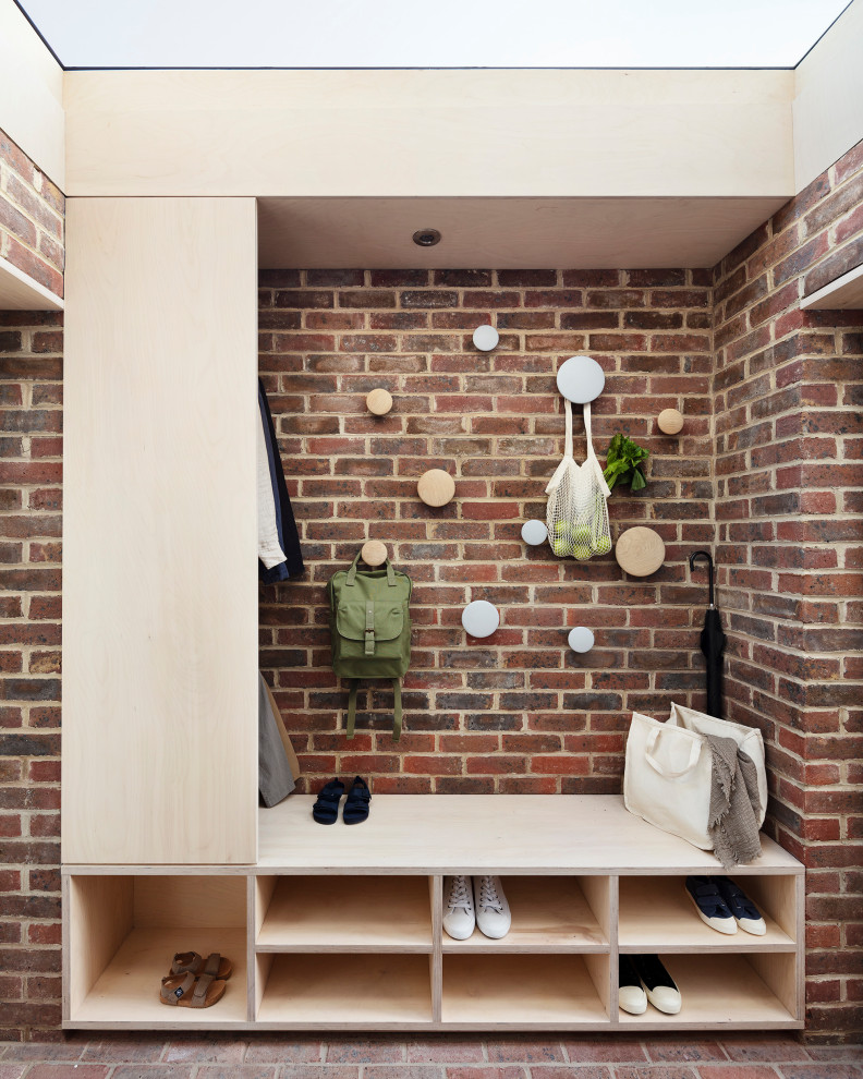 Inspiration for a small contemporary brick floor, wood ceiling and brick wall entryway remodel in Hertfordshire with a gray front door