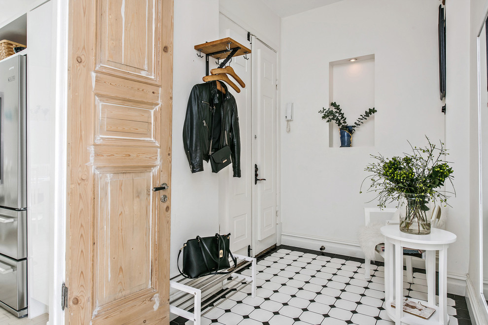 Inspiration for a mid-sized scandinavian entryway remodel in Gothenburg with white walls and a white front door