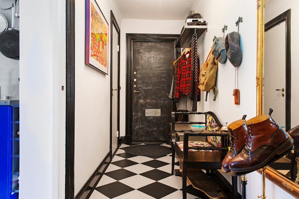 Photo of a medium sized bohemian hallway in Stockholm with white walls, a single front door, a black front door and ceramic flooring.