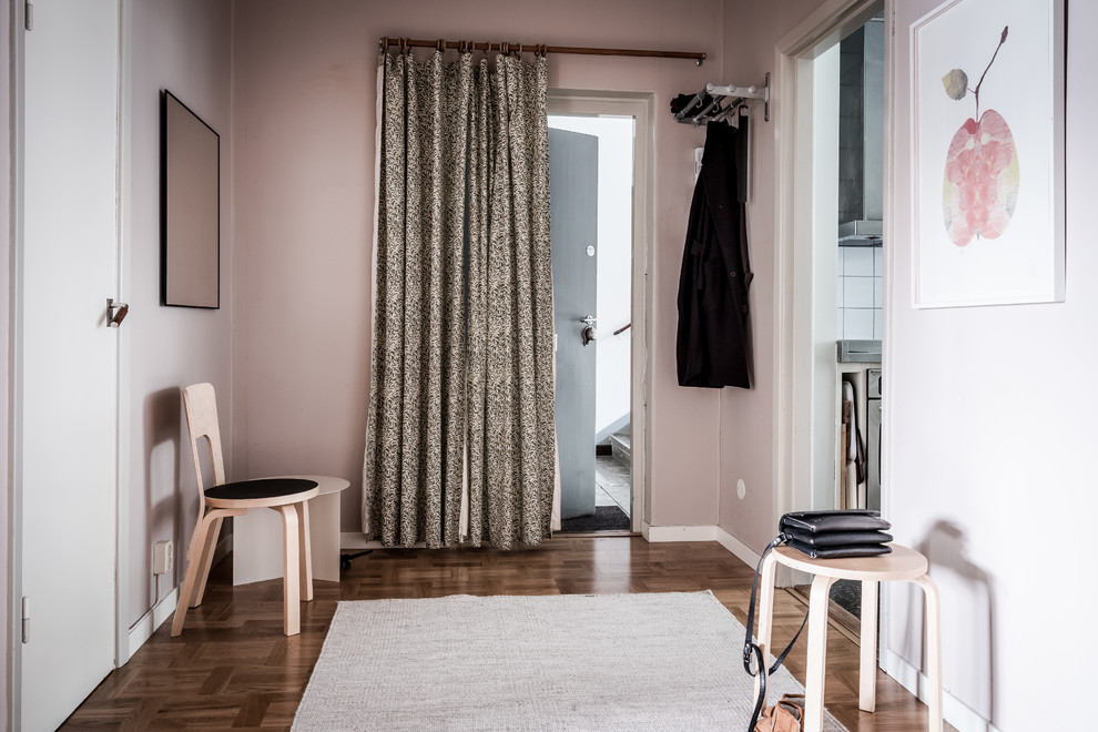 Mid-sized danish medium tone wood floor entryway photo in Gothenburg