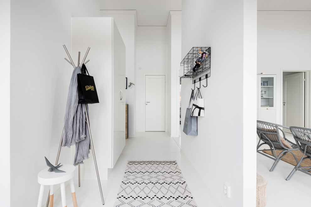 Scandi hallway in Gothenburg with white walls, a single front door, painted wood flooring, a white front door and white floors.