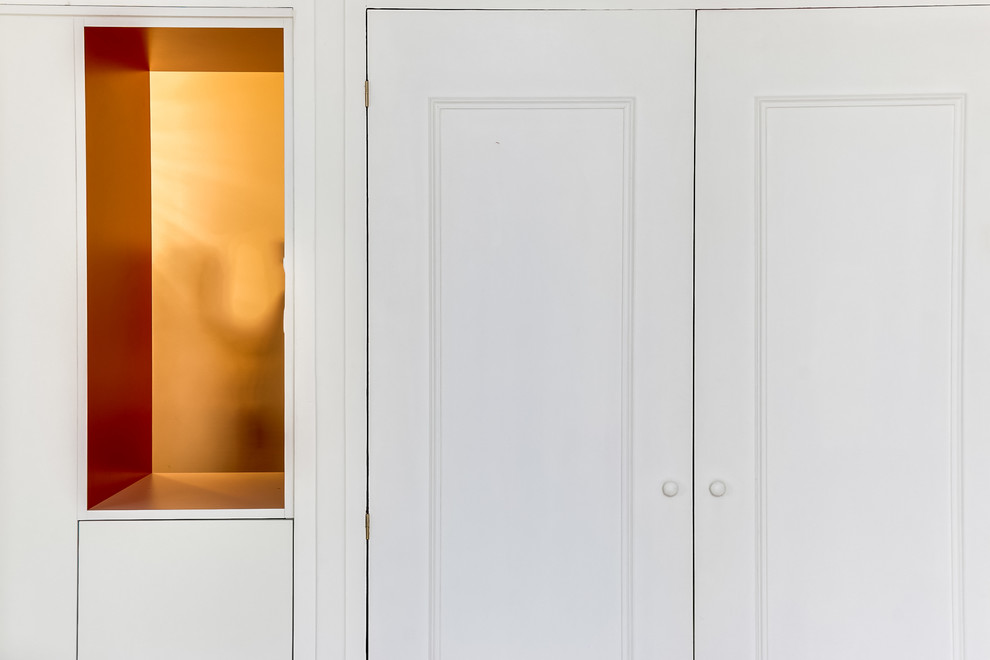 Immagine di un ingresso con vestibolo design di medie dimensioni con pareti bianche, parquet chiaro, una porta singola, una porta bianca e pavimento marrone