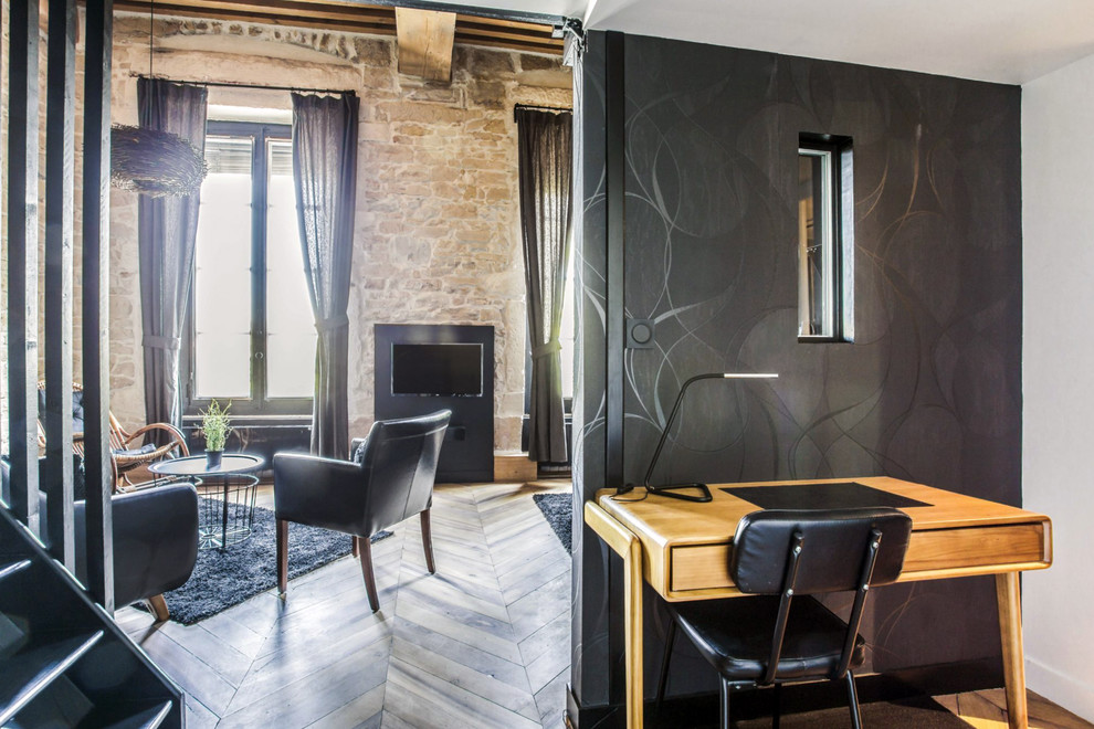 This is an example of a medium sized contemporary entrance in Lyon with black walls, light hardwood flooring, brown floors, exposed beams and wallpapered walls.