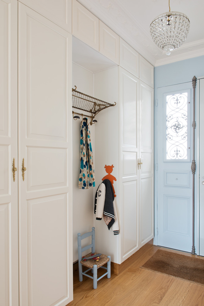 Inspiration for a mid-sized transitional medium tone wood floor mudroom remodel in Paris