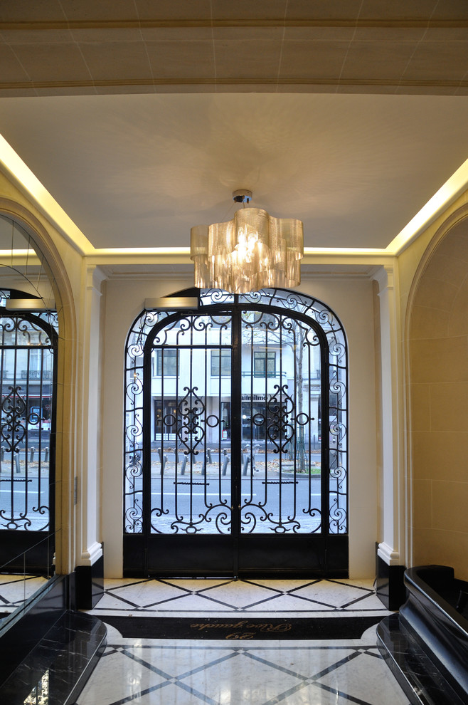 Photo of a classic foyer in Paris with a double front door.