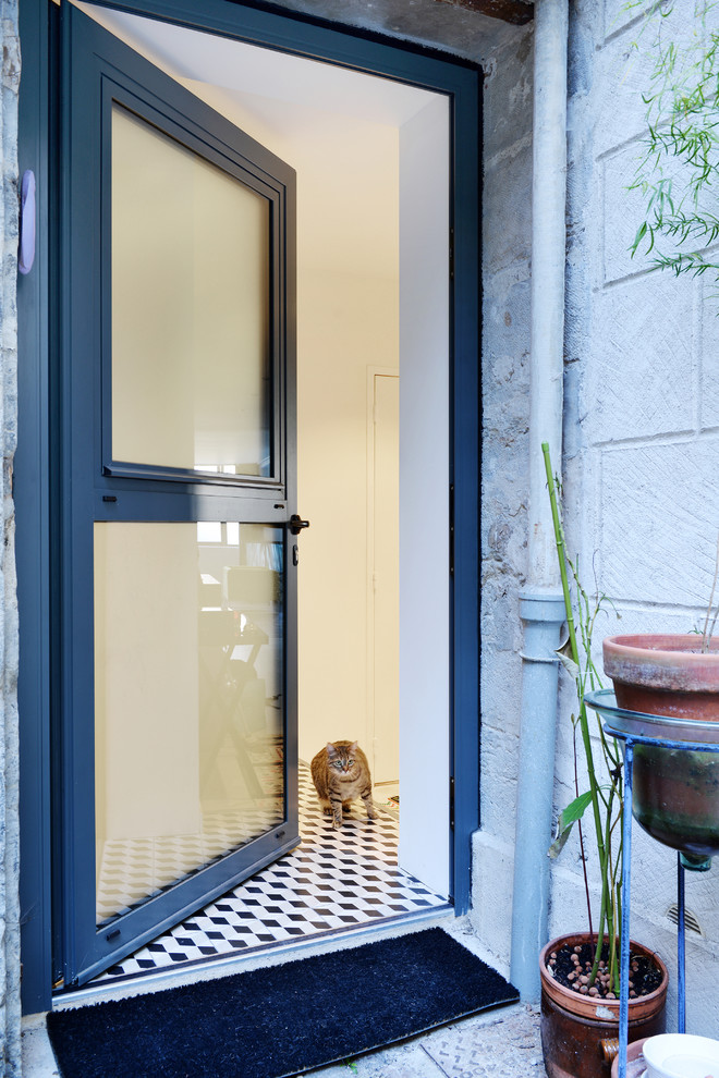 Example of a trendy single front door design in Lyon with white walls and a blue front door