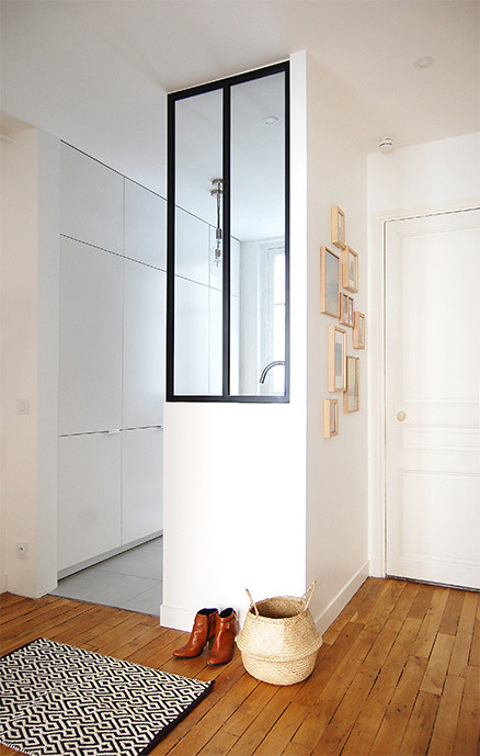 Design ideas for a small scandi boot room in Paris with white walls, medium hardwood flooring, a single front door, a white front door and brown floors.