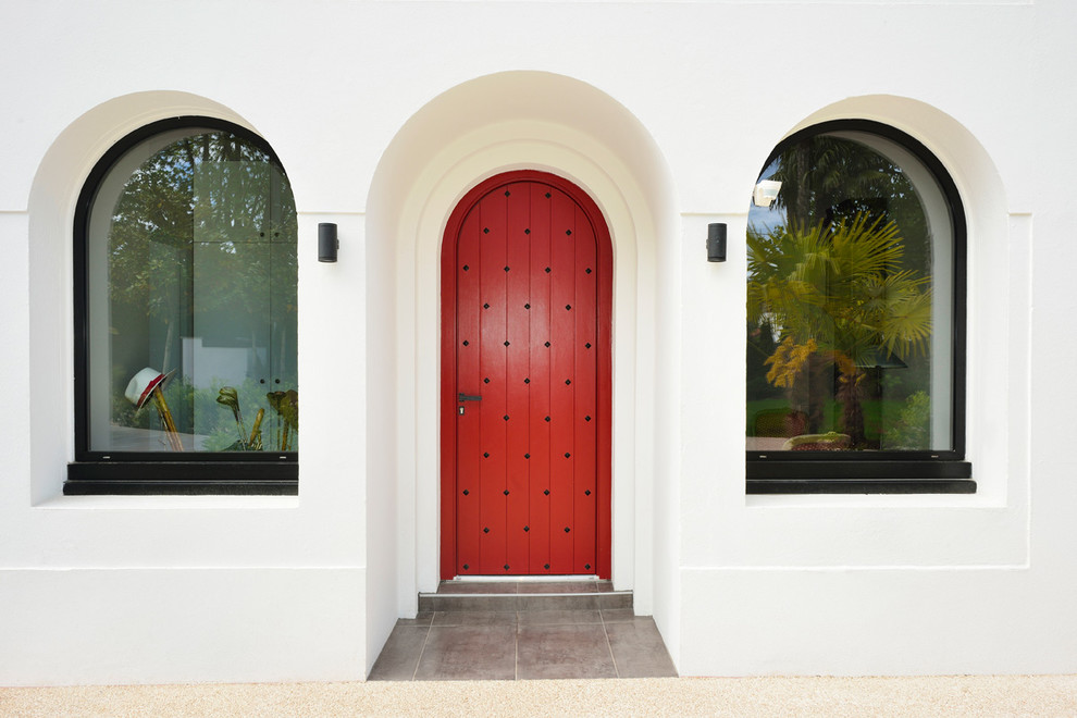 Entryway - mid-sized mediterranean entryway idea in Bordeaux with white walls and a red front door
