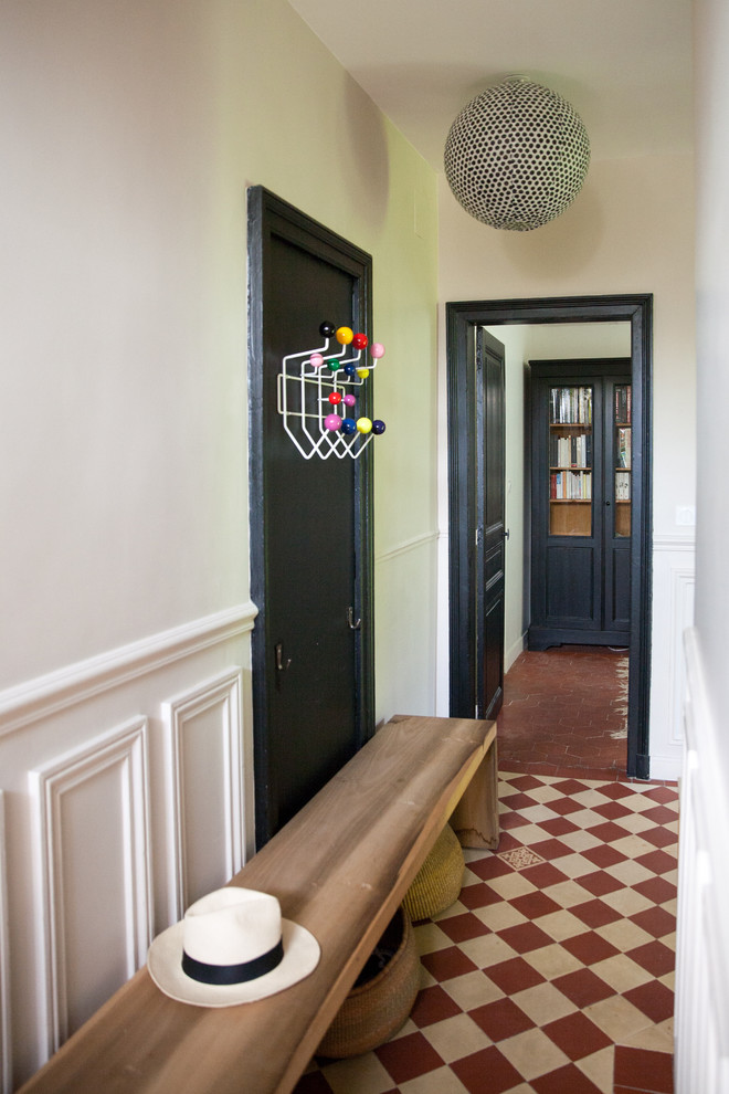 Aménagement d'une entrée moderne de taille moyenne avec un mur blanc et un couloir.