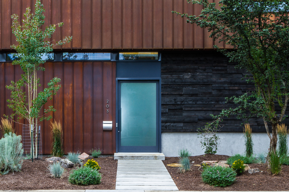 This is an example of an urban front door in Seattle with a glass front door.