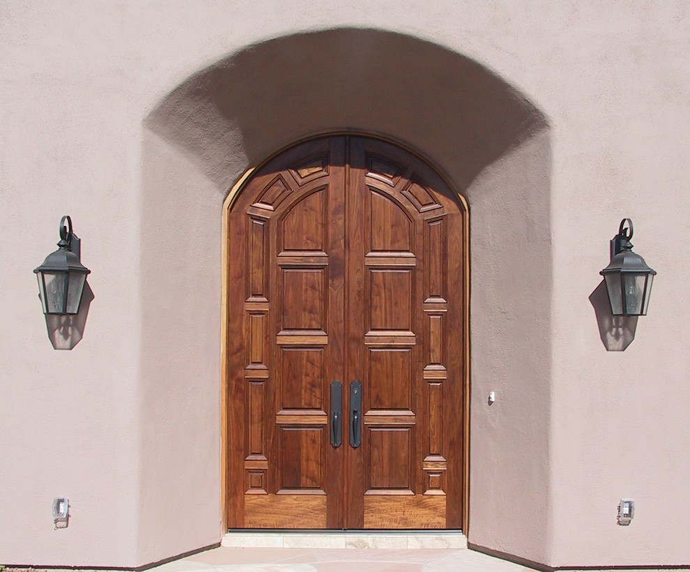 Photo of a large mediterranean front door in Phoenix with beige walls, terrazzo flooring, a double front door and a medium wood front door.