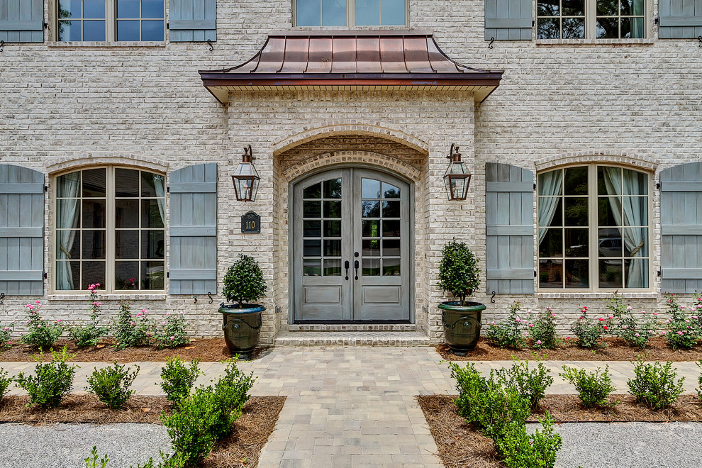 This is an example of a traditional front door in Miami with a double front door and a grey front door.