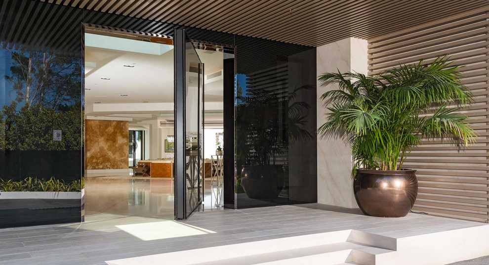 Example of a large trendy entryway design in Los Angeles with a glass front door
