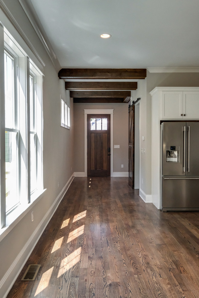 Esempio di un ingresso con anticamera american style di medie dimensioni con pareti grigie, pavimento in legno massello medio, pavimento marrone, una porta singola e una porta in legno bruno