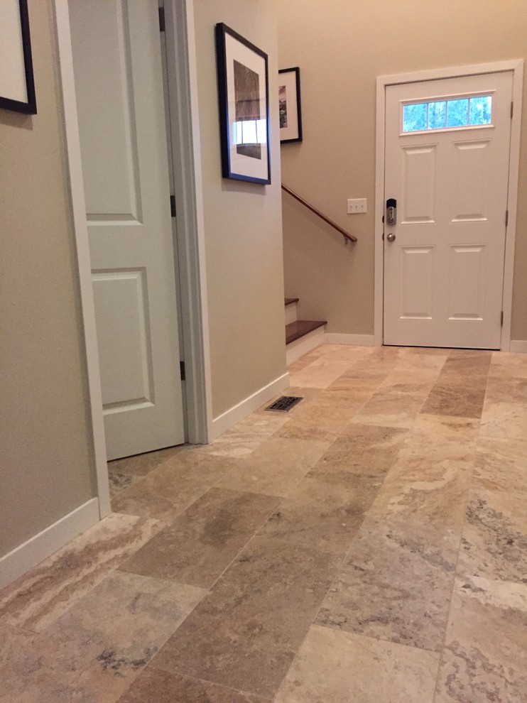 Entryway - mid-sized transitional travertine floor and brown floor entryway idea in Seattle with a white front door and beige walls