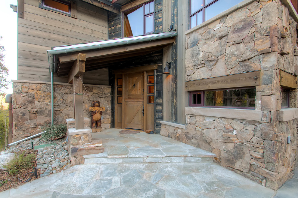 Inspiration for a rustic entrance in Denver with a stable front door.