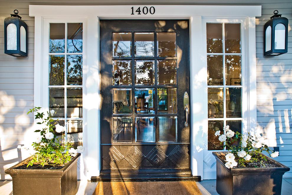 Ejemplo de puerta principal de estilo americano extra grande con paredes grises, suelo de madera oscura, puerta simple y puerta negra