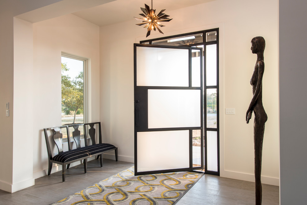 Photo of a contemporary front door in Austin with white walls, a pivot front door and a glass front door.