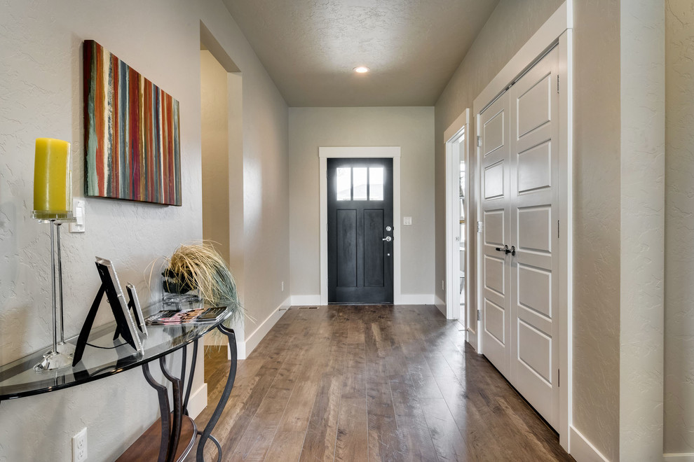 Inspiration for a large classic front door in Boise with beige walls, medium hardwood flooring, a single front door and a black front door.