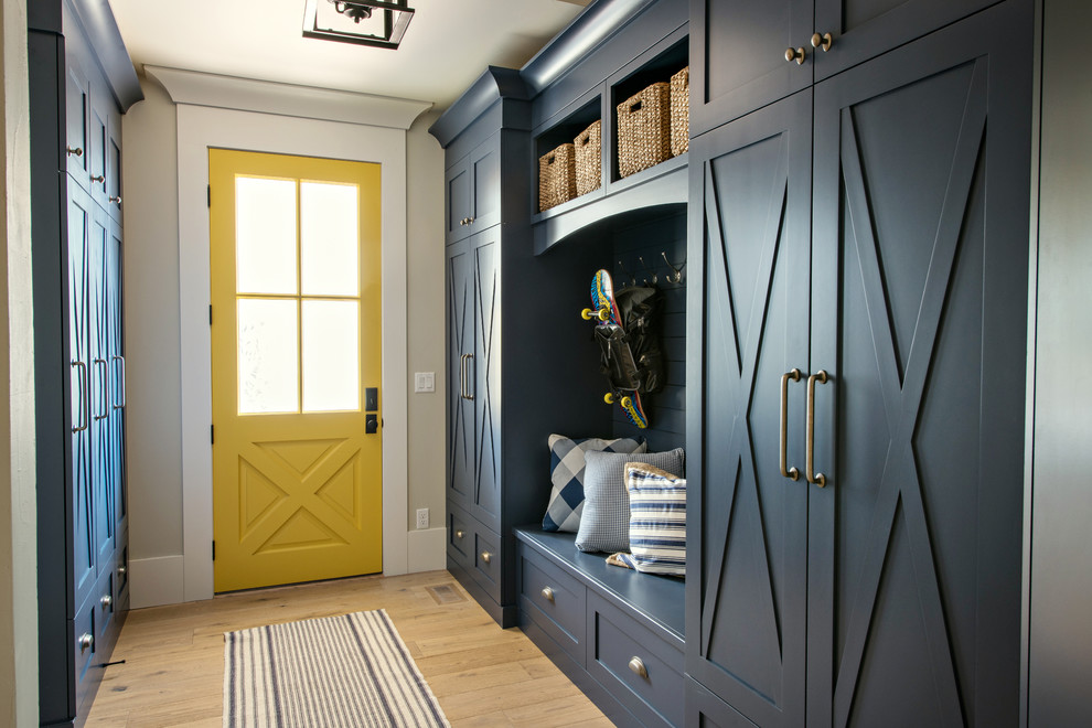 Transitional light wood floor and beige floor mudroom photo in Denver with beige walls and a yellow front door