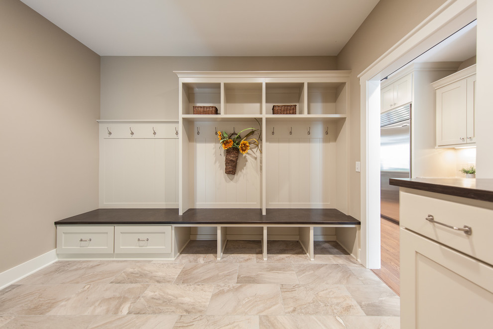 Photo of a large traditional boot room in Minneapolis with grey walls, porcelain flooring and beige floors.