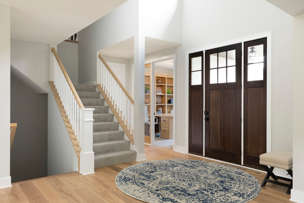 Transitional light wood floor and brown floor entryway photo in Minneapolis with gray walls and a dark wood front door