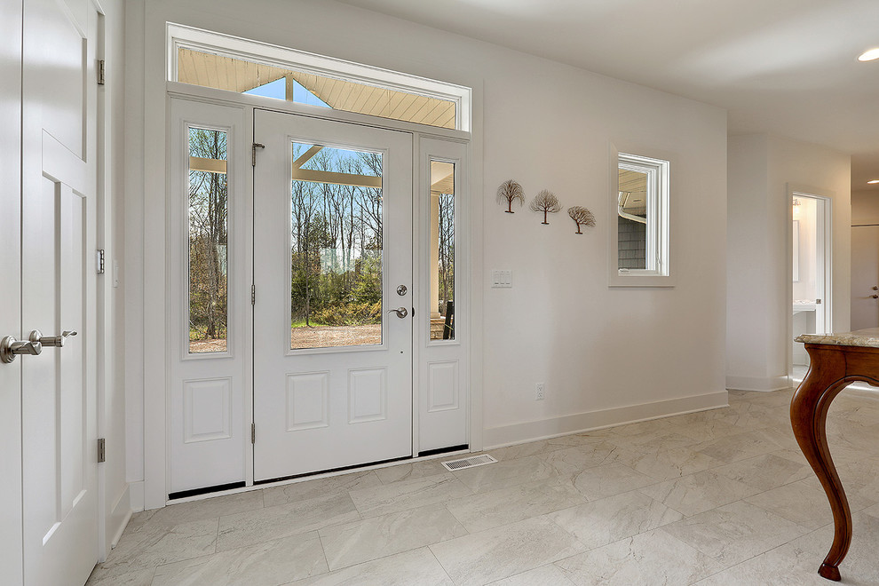 This is an example of a medium sized classic foyer in Other with white walls, ceramic flooring, a white front door and white floors.