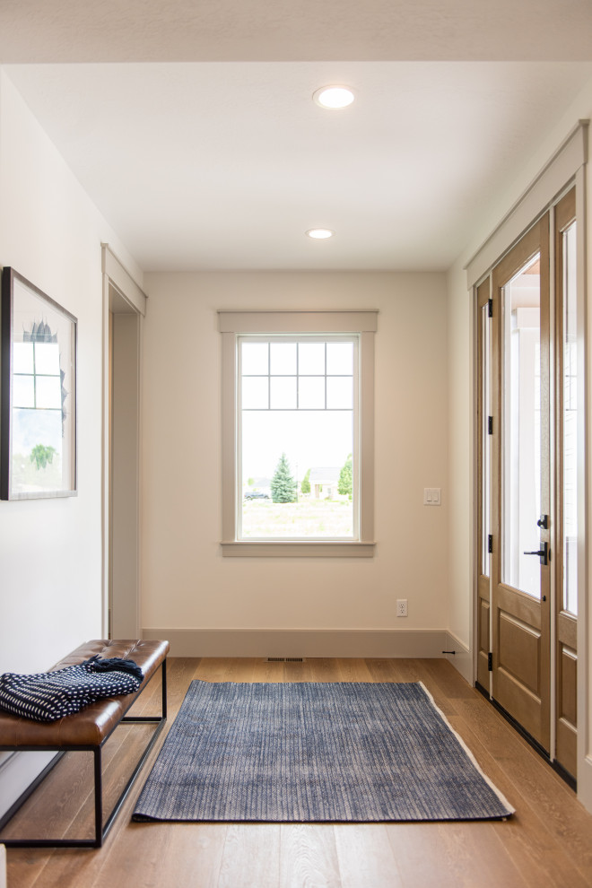 Photo of a large traditional foyer in Salt Lake City with beige walls, medium hardwood flooring, a single front door, a glass front door and brown floors.