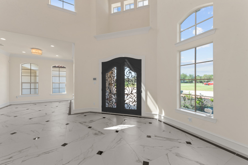 Design ideas for a large mediterranean foyer in Dallas with white walls, porcelain flooring, a double front door, a black front door, white floors and a vaulted ceiling.