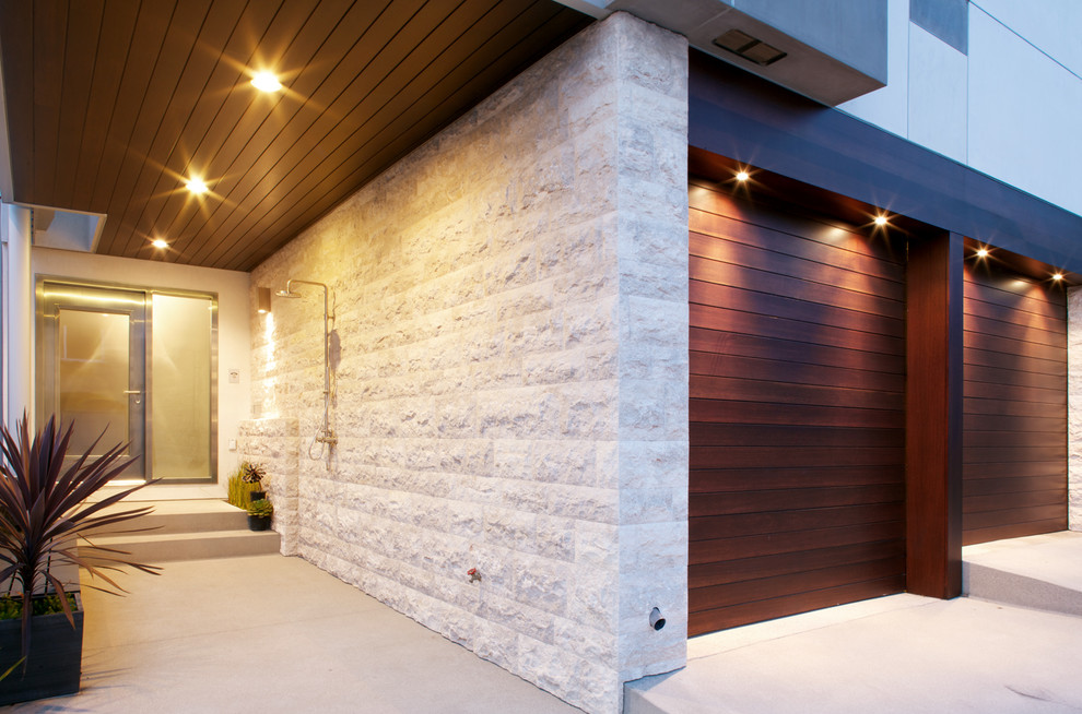 This is an example of a medium sized contemporary front door in Los Angeles with white walls, concrete flooring, a single front door and a glass front door.
