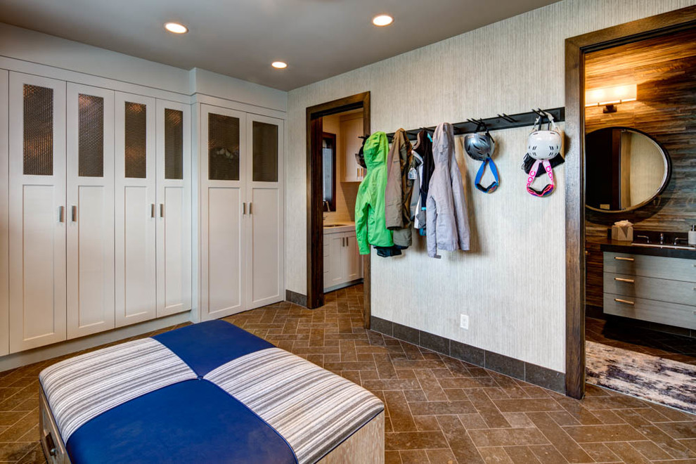 Inspiration for a mid-sized transitional brick floor and brown floor mudroom remodel in Salt Lake City with beige walls
