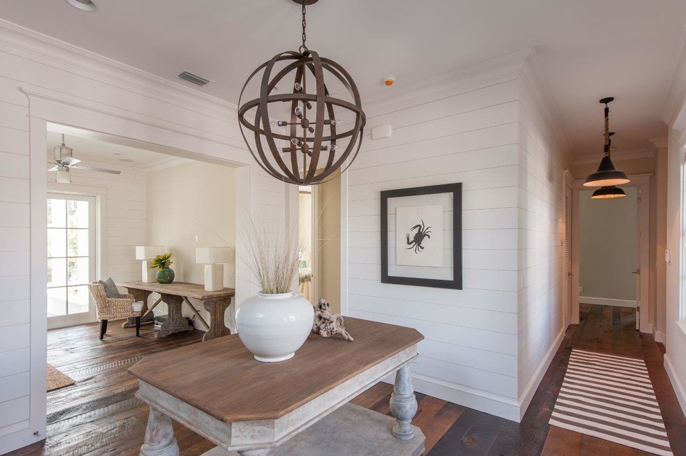 Beach style dark wood floor foyer photo in Tampa with white walls