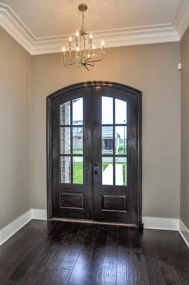 Mid-sized arts and crafts dark wood floor entryway photo in New Orleans with beige walls and a dark wood front door
