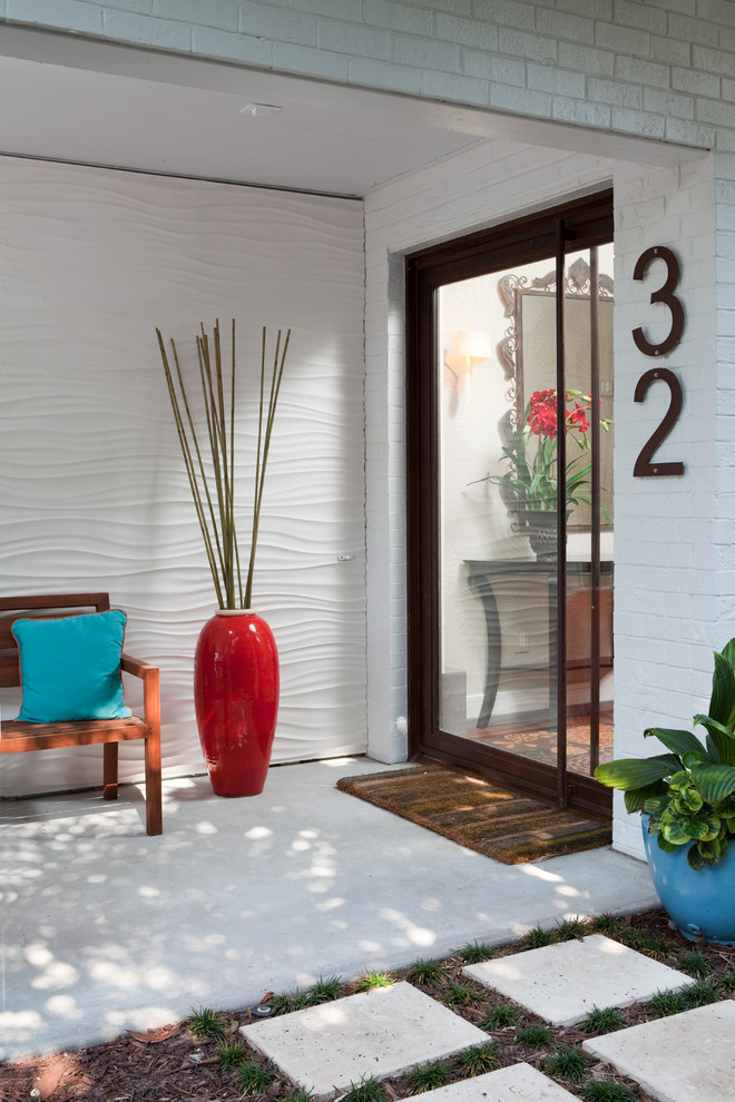 Example of a trendy single front door design in Wilmington with white walls and a glass front door