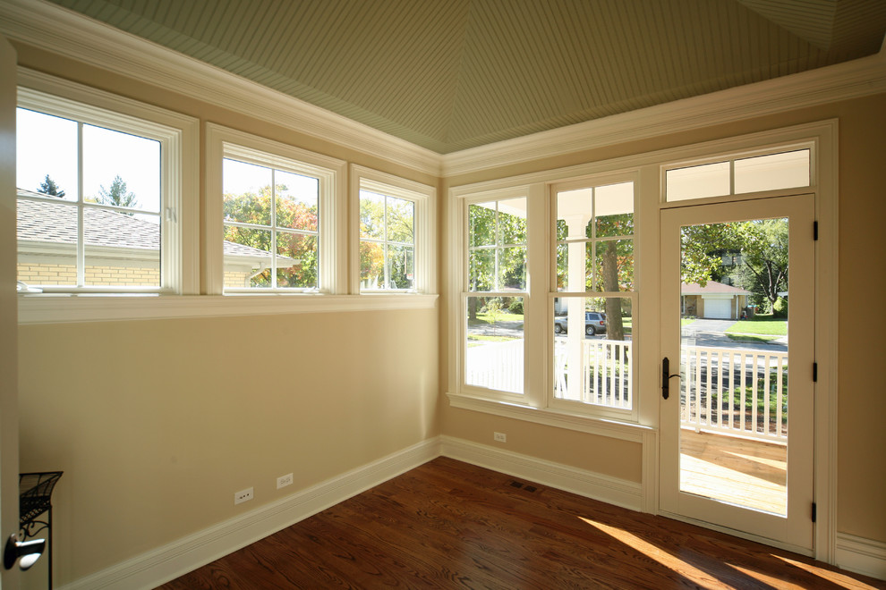 Example of a mid-sized classic medium tone wood floor entryway design in Chicago with beige walls and a glass front door