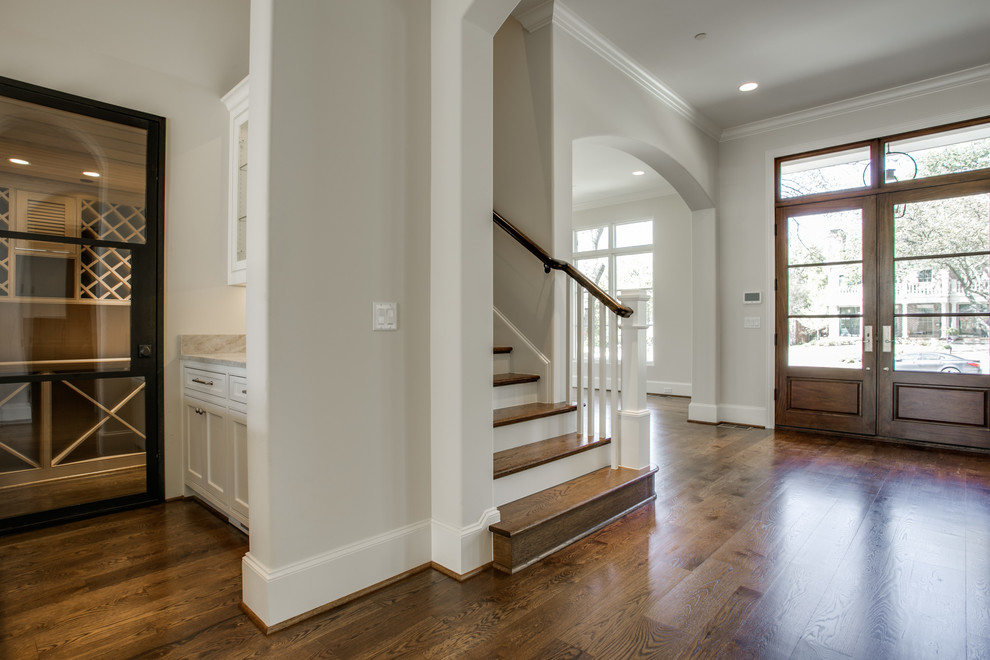 Photo of a large classic foyer in Dallas with medium hardwood flooring, a double front door and a dark wood front door.