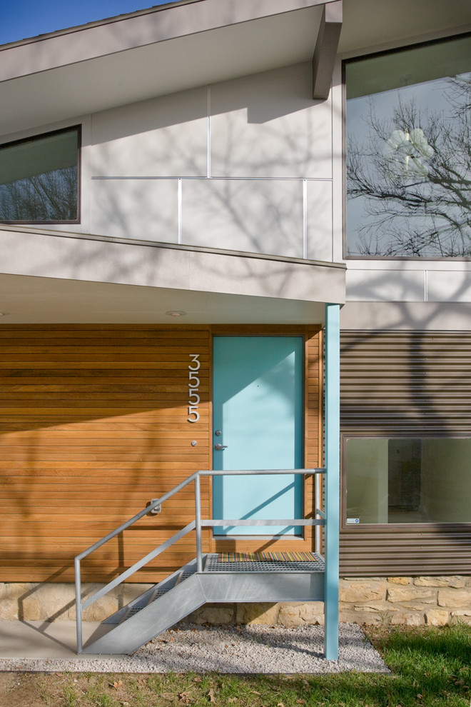 This is an example of a contemporary front door in Kansas City with a single front door and a blue front door.