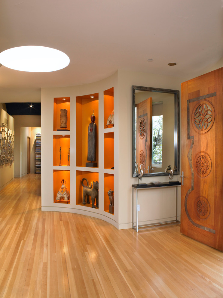 Inspiration for a contemporary foyer in Denver with light hardwood flooring and brown floors.