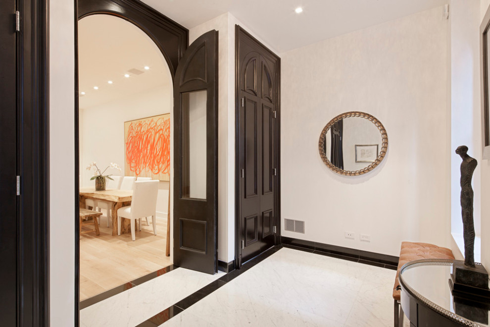 Photo of a contemporary entrance in New York with white walls.