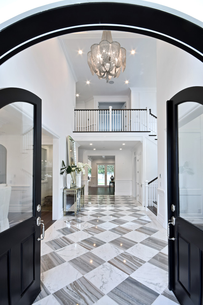 Inspiration for an expansive foyer in Los Angeles with white walls, marble flooring, a black front door and a double front door.