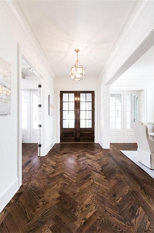 Inspiration for a large farmhouse dark wood floor and brown floor entryway remodel in Atlanta with white walls and a dark wood front door