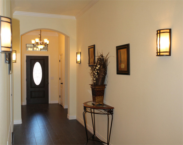 Diseño de hall clásico de tamaño medio con paredes beige, suelo de madera oscura, puerta simple, puerta de madera oscura y suelo marrón