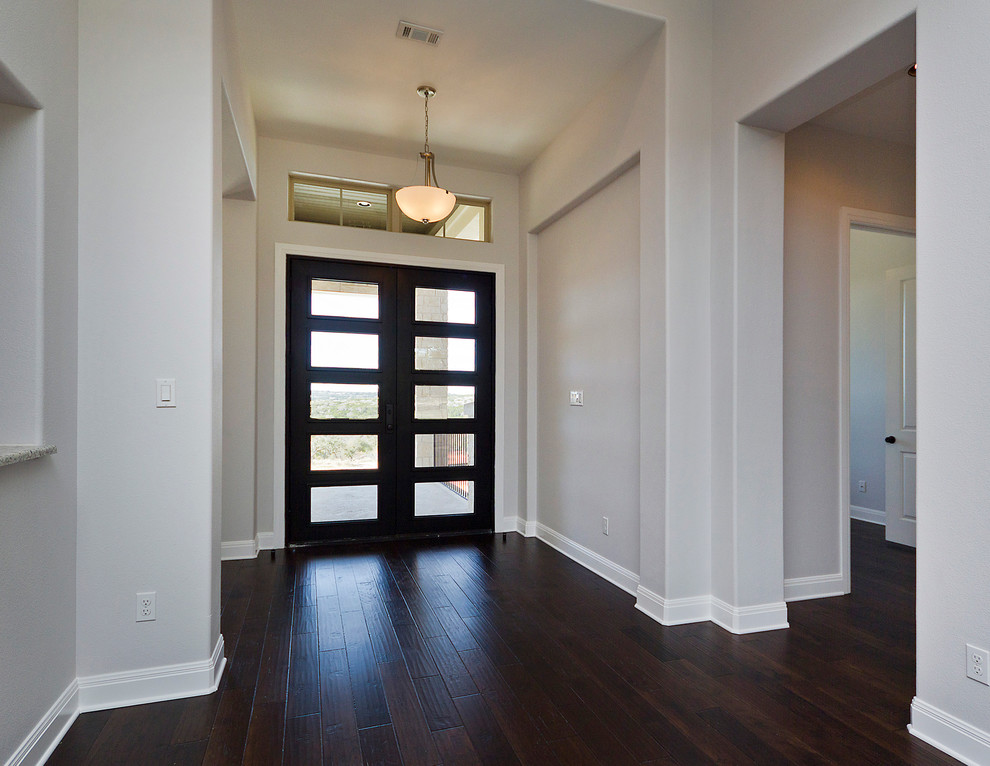 Photo of a medium sized classic foyer in Austin with grey walls, dark hardwood flooring, a double front door and a dark wood front door.