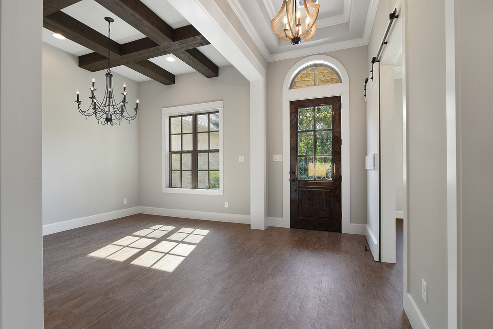 Example of a mid-sized transitional porcelain tile entryway design in Houston with gray walls and a dark wood front door