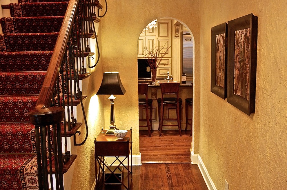 Example of a mid-sized classic medium tone wood floor entry hall design in Kansas City with yellow walls