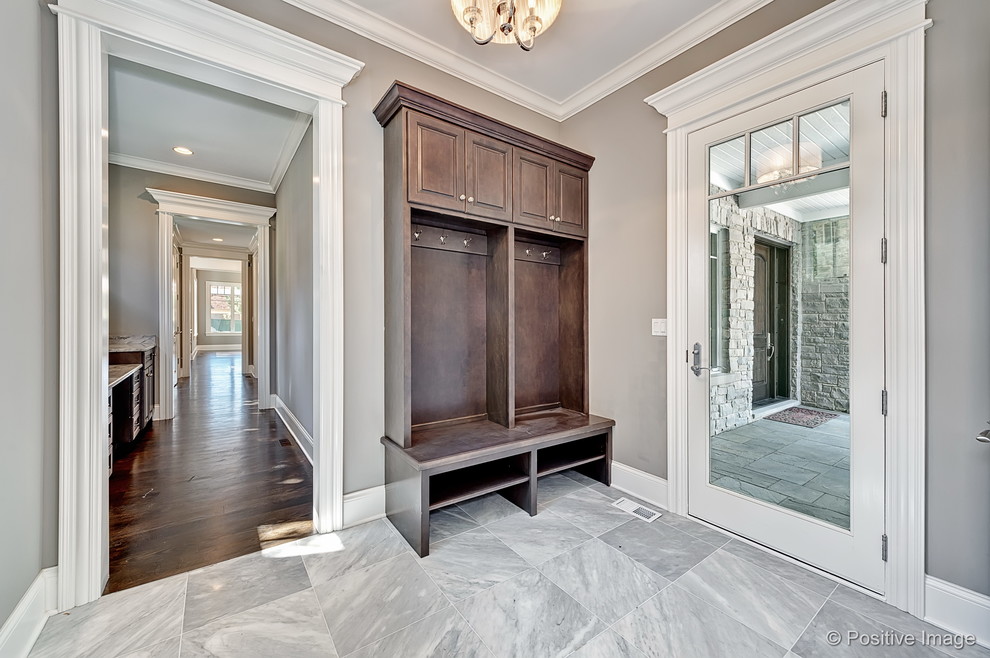 Large elegant marble floor and gray floor entryway photo in Chicago with gray walls and a dark wood front door