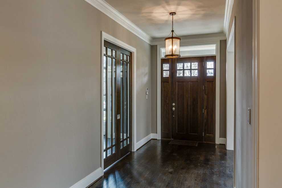 Inspiration for a classic foyer in Dallas with a dark wood front door, beige walls, dark hardwood flooring and a single front door.