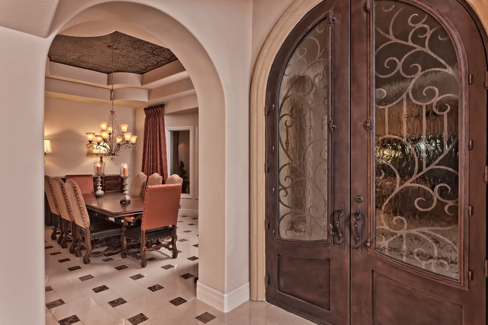 Photo of a large mediterranean entrance in Austin with beige walls, porcelain flooring and beige floors.